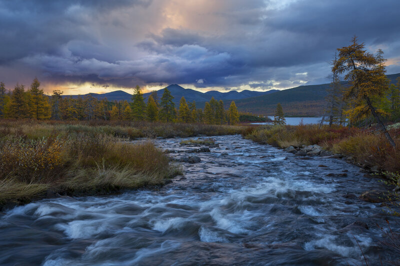 River Flowing Through Forest — Blue, Dramatic, Sunset, Photograph, Mountains