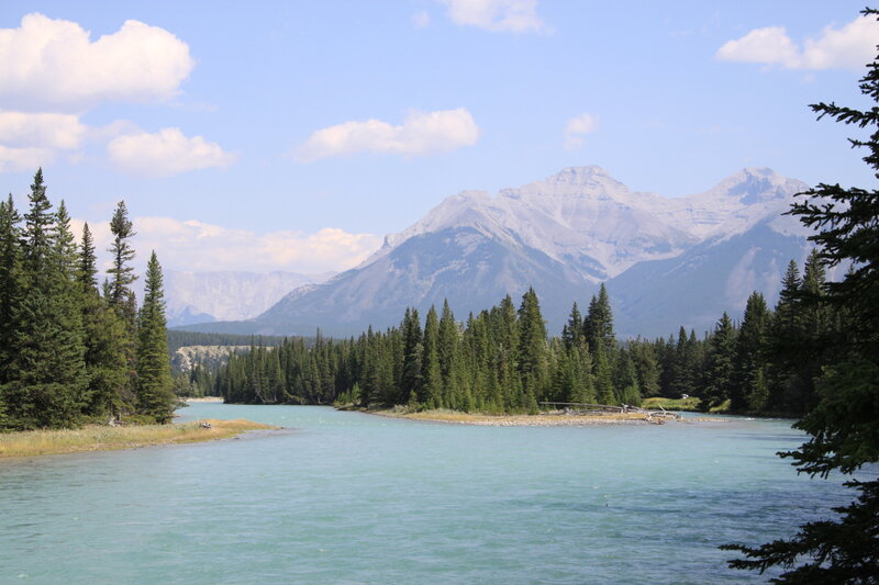 River Flowing Through Forest — Blue, Serene, Afternoon, Photograph, Mountains