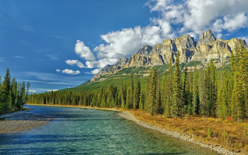 River Flowing Through Forest — Blue, Serene, Afternoon, Photograph, Mountains, Trees, Sky, Green