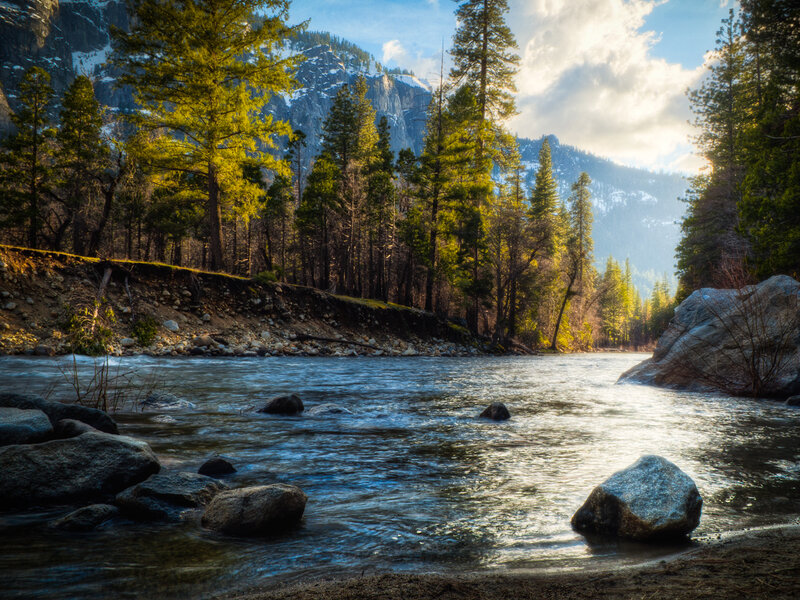 River Flowing Through Forest — Blue, Serene, Afternoon, Photograph, Trees, Mountains