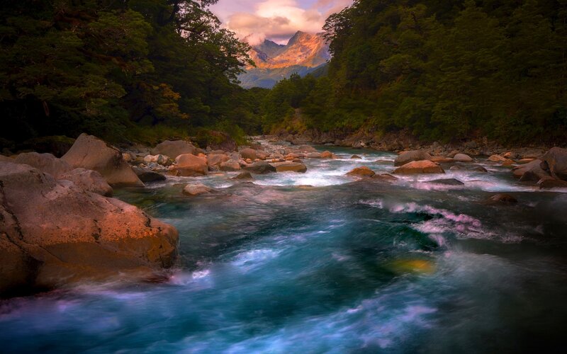 River Flowing Through Forest — Blue, Serene, Sunset, Photograph, Mountain