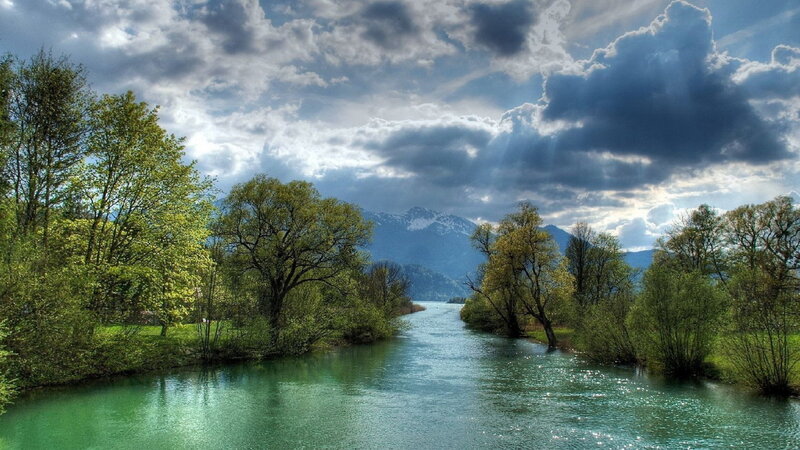 River Flowing Through Forest — Green, Dramatic, Afternoon, Photograph, Trees, Mountains, Clouds