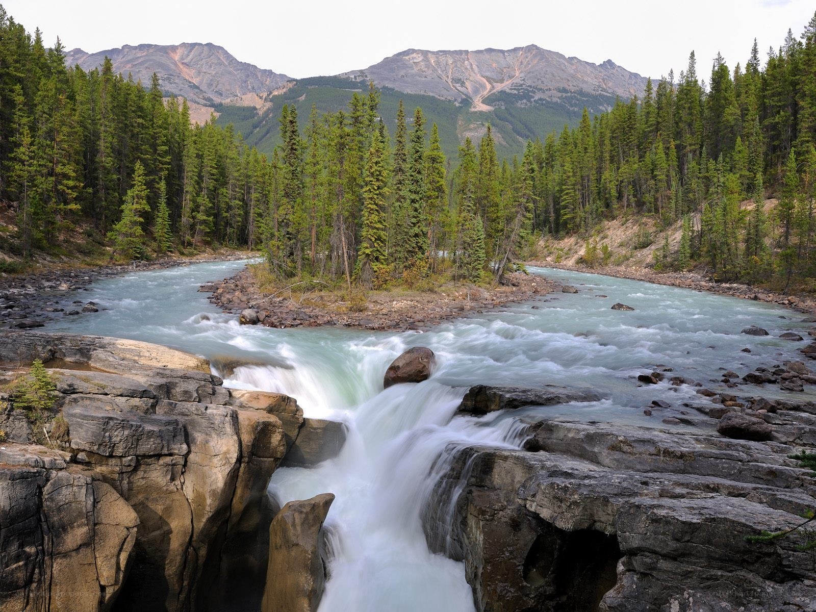 River flowing through forested canyon