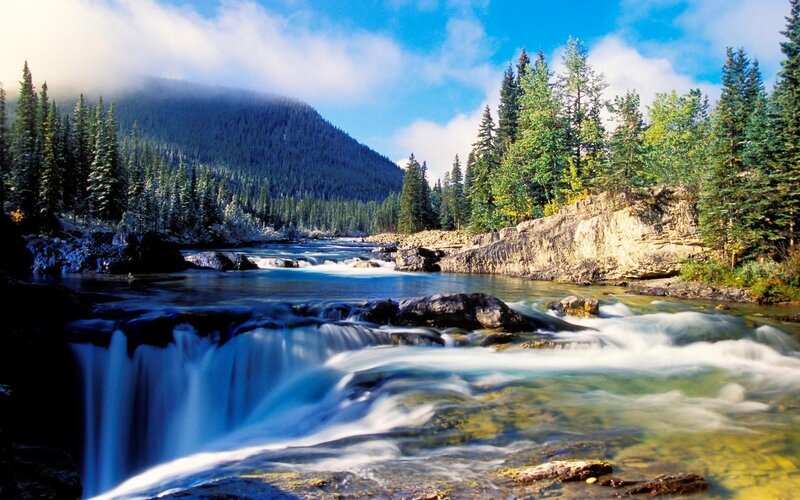 River flowing through forested mountains