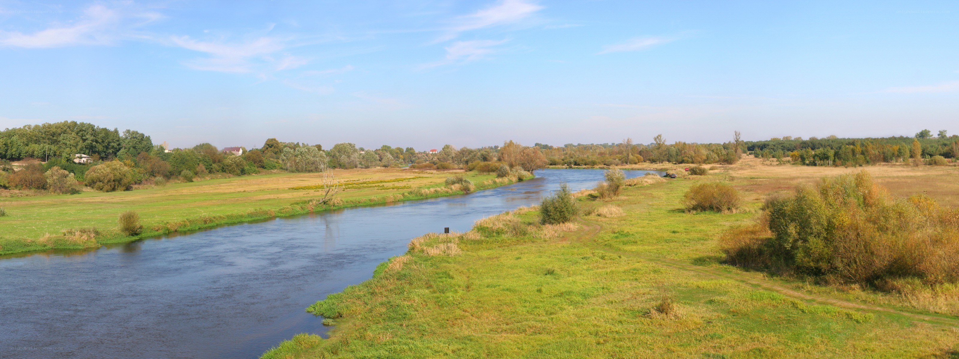 River flowing through green fields