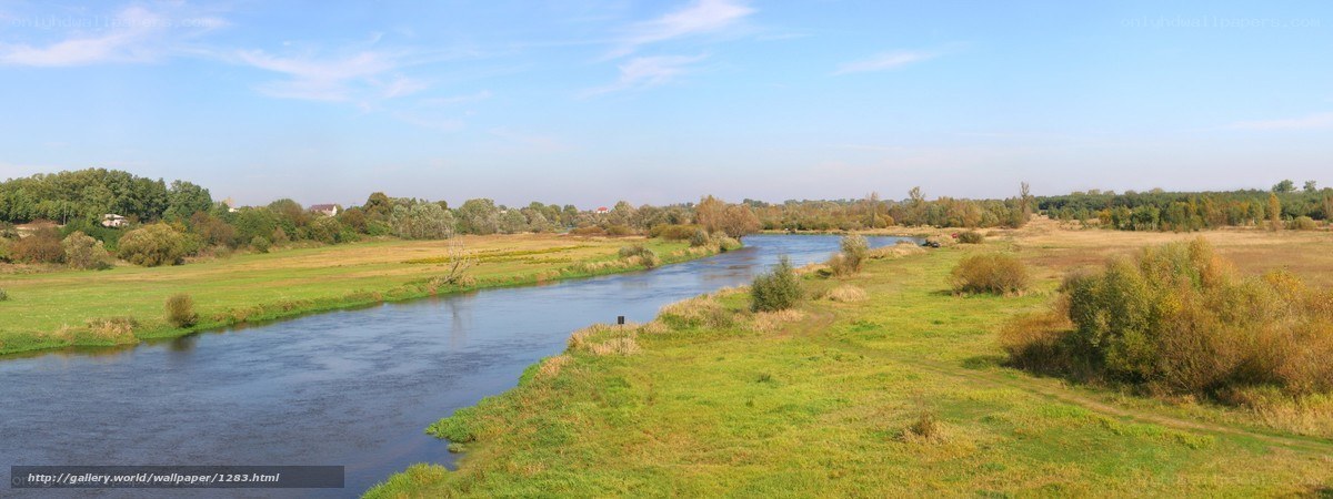 River flowing through green fields