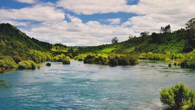 River flowing through green hills
