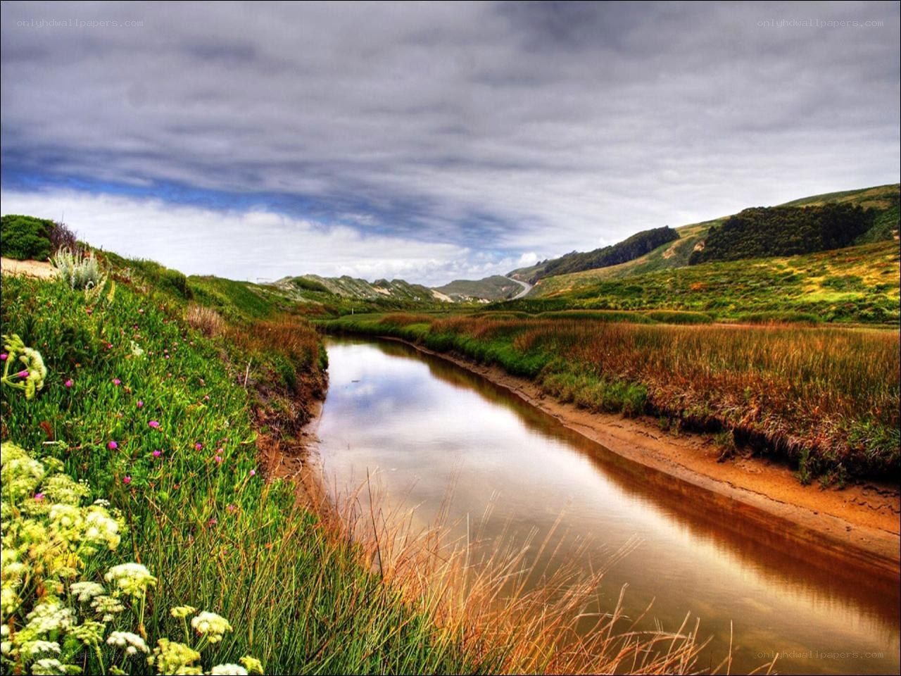 River flowing through green hills