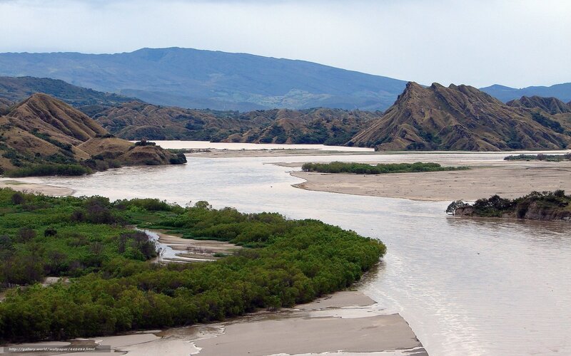 River flowing through hilly landscape