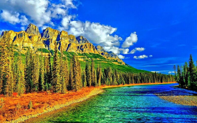 River Flowing Through Mountains — Blue, Dramatic, Afternoon, Photograph, Trees
