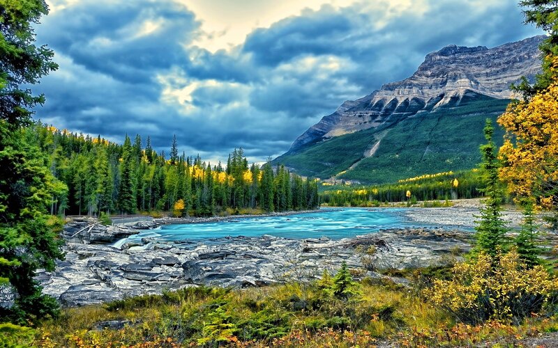 River Flowing Through Mountains — Blue, Dramatic, Autumn, Photograph, Forest, Clouds