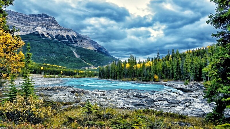 River Flowing Through Mountains — Blue, Dramatic, Autumn, Photograph, Mountain, Forest