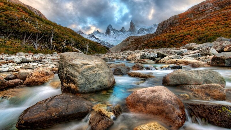 River Flowing Through Mountains — Blue, Dramatic, Autumn, Photograph, Rocks, Trees