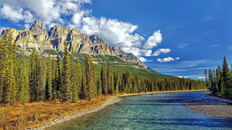 River Flowing Through Mountains — Blue, Serene, Afternoon, Photograph, Trees, Clouds