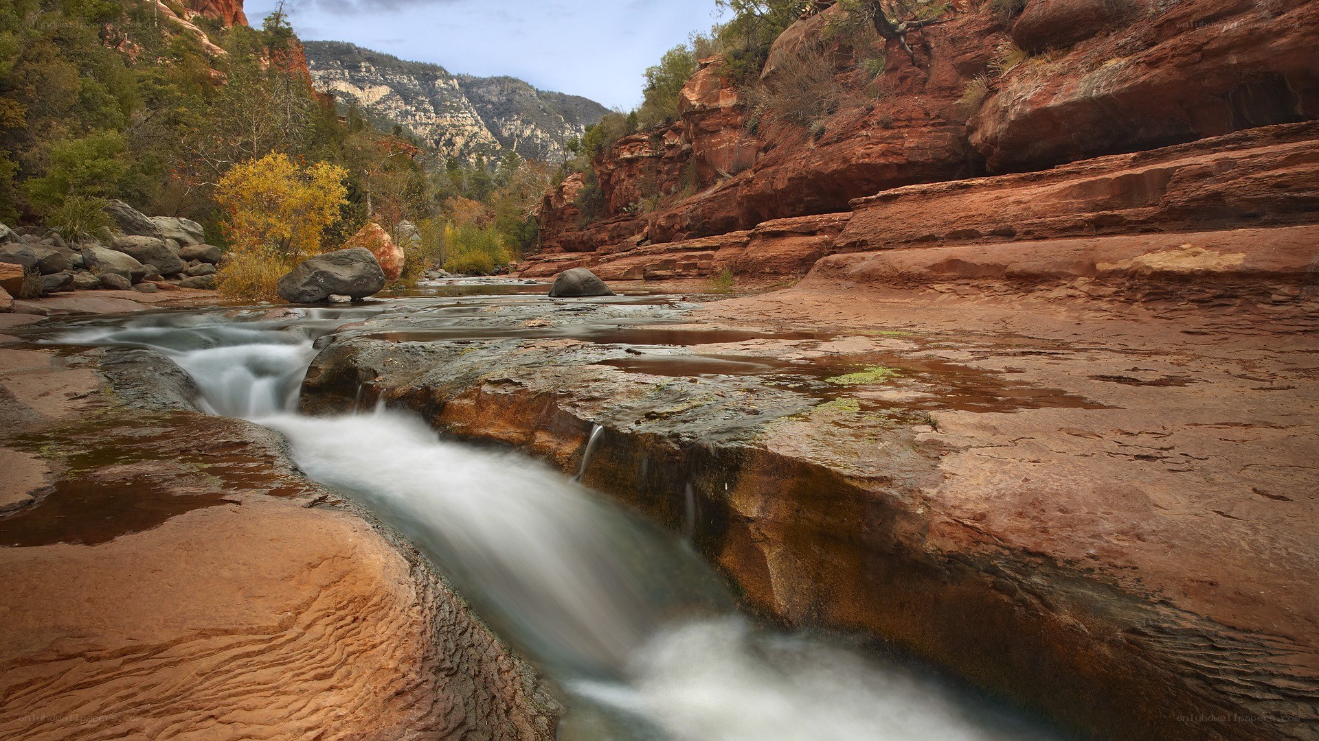 River flowing through red rock canyon