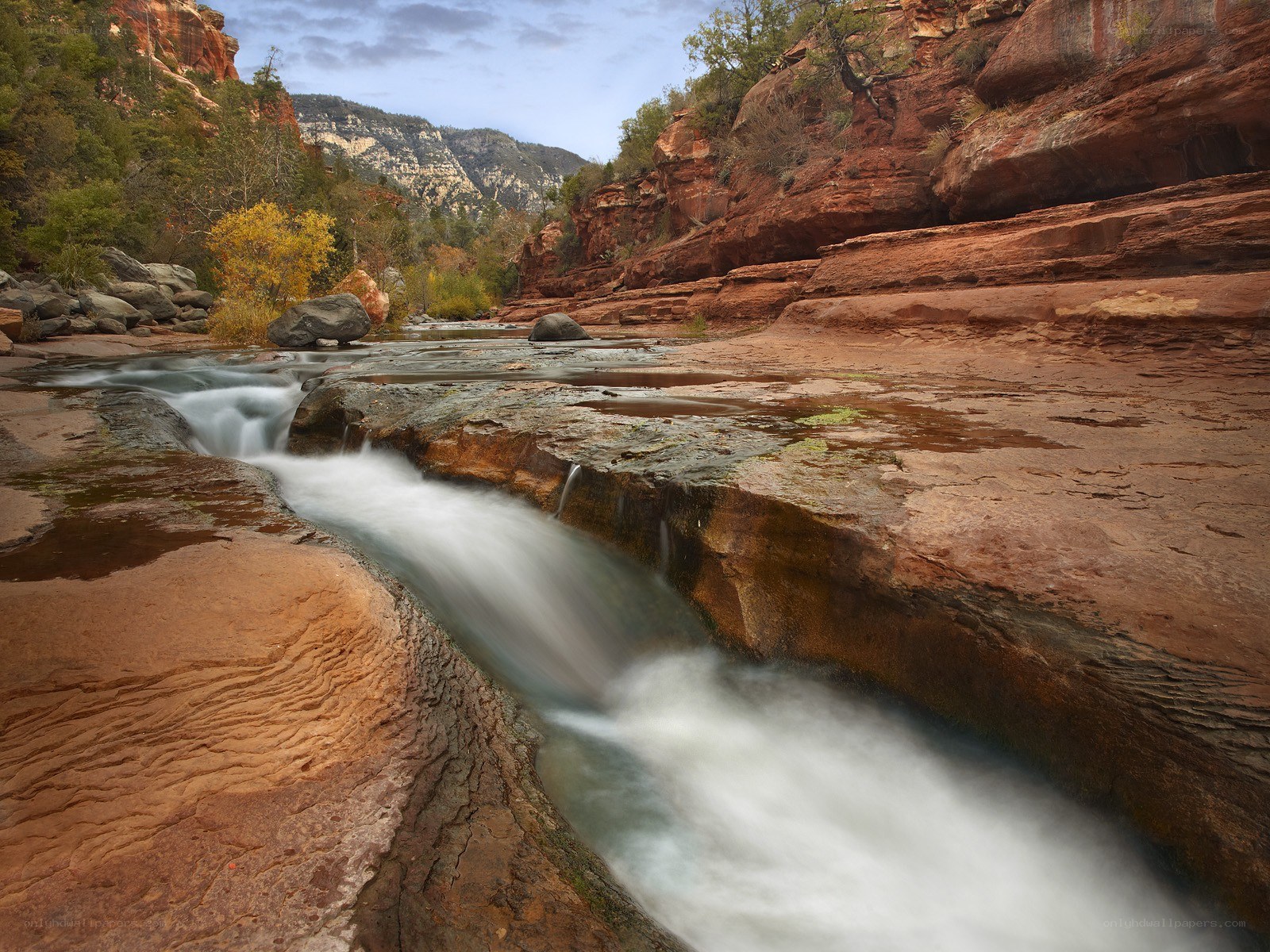 River flowing through red rock canyon