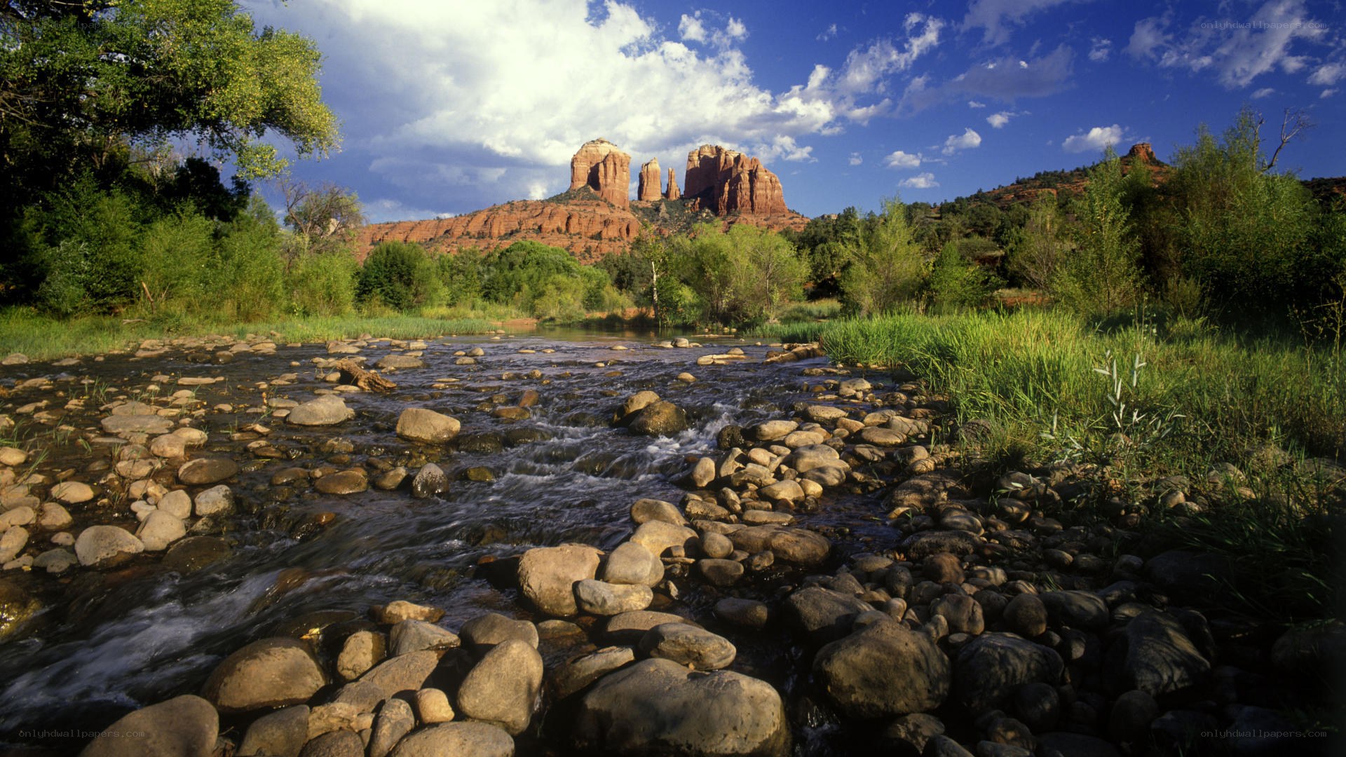 River flowing through red rock canyon