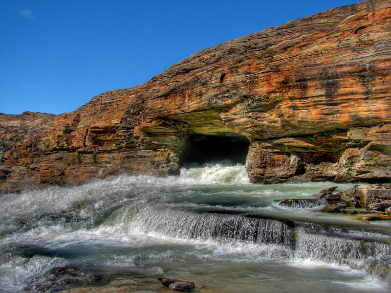 River flowing through rock arch