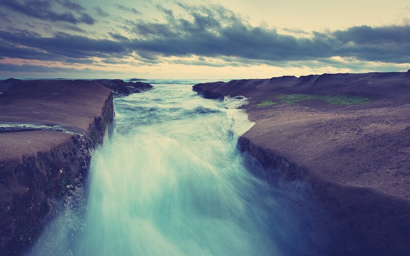 River Flowing Through Rocks — Blue, Dramatic, Sunset, Photograph