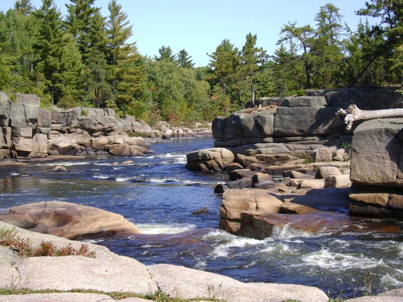 River Flowing Through Rocks — Blue, Serene, Afternoon, Photograph, Trees, Fallen Log