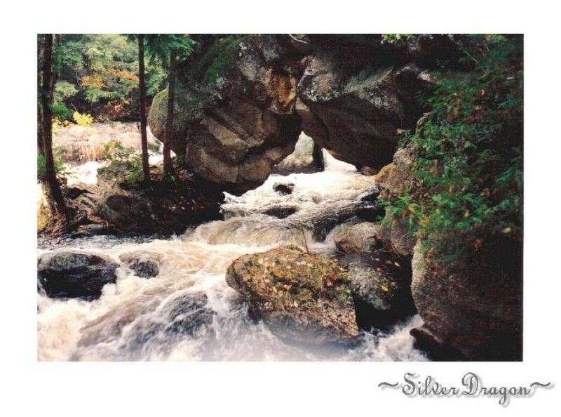 River Flowing Through Rocks