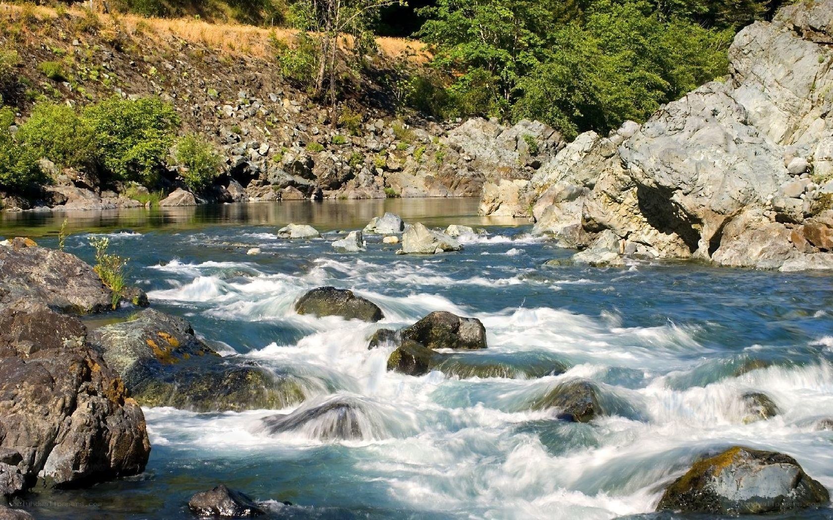 River flowing through rocky landscape