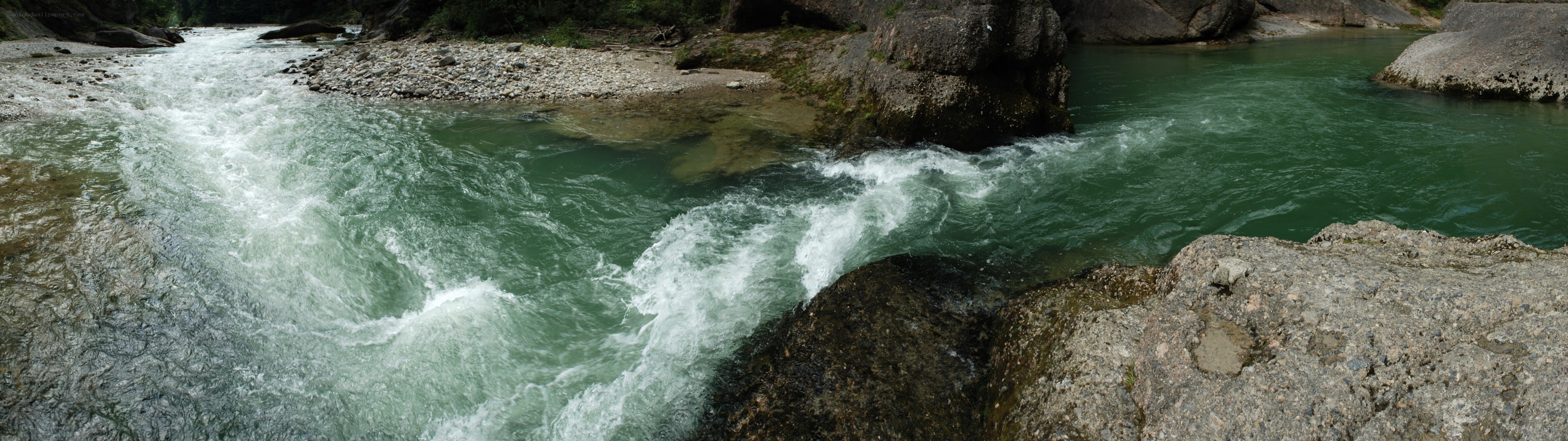 river flowing through rocky terrain