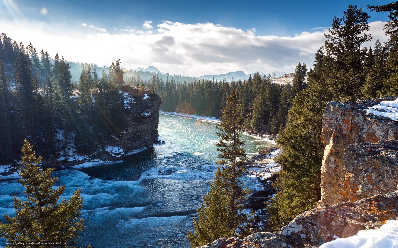 river flowing through snowy canyon