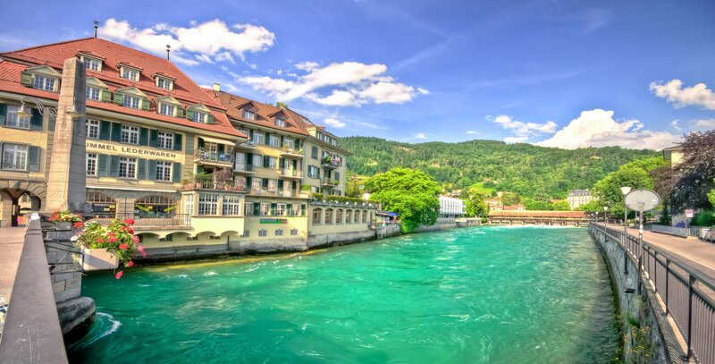River Flowing Through Town — Blue, Serene, Afternoon, Photograph