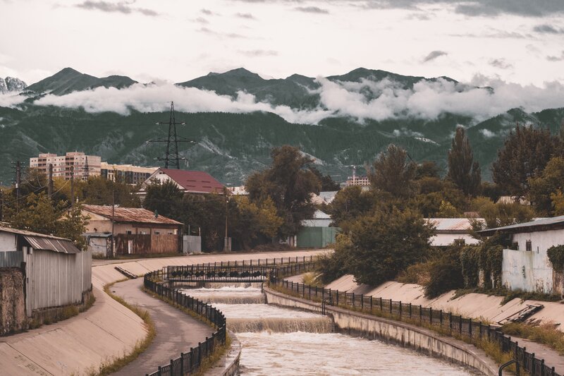River Flowing Through Town — Green, Overcast