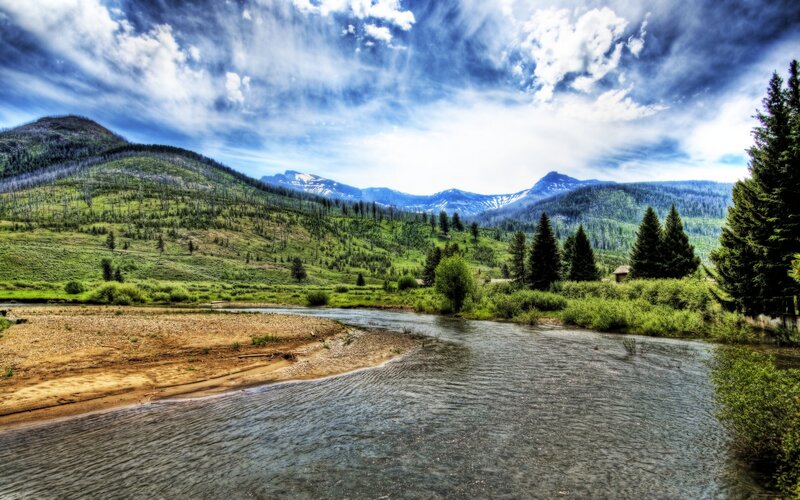 River Flowing Through Valley — Blue, Dramatic, Afternoon, Photograph, Mountains, Trees