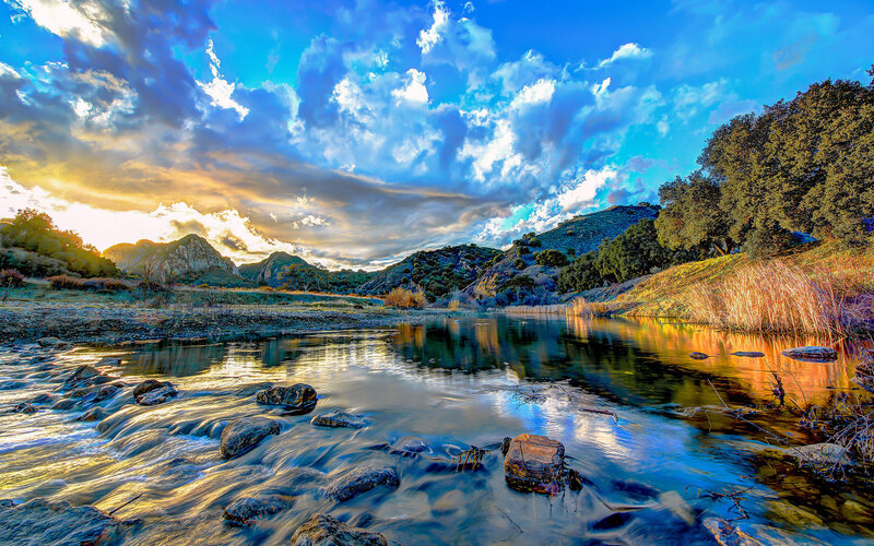 River Flowing Through Valley — Blue, Dramatic, Sunset, Photograph, Mountains, Trees