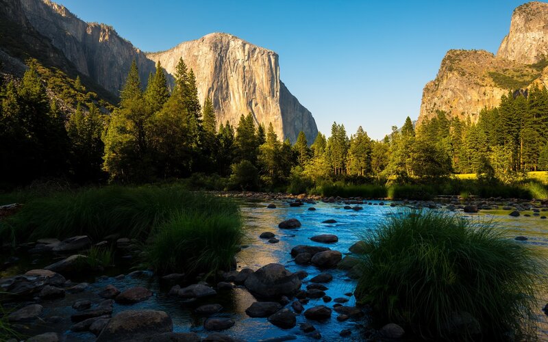 River Flowing Through Valley — Blue, Serene, Morning, Photograph, Mountains, Trees, Rocks