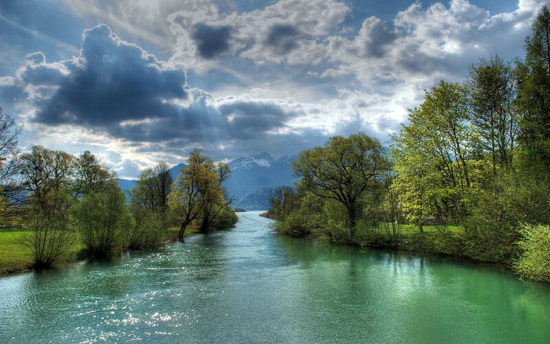 River Flowing Through Valley — Green, Dramatic, Afternoon, Photograph