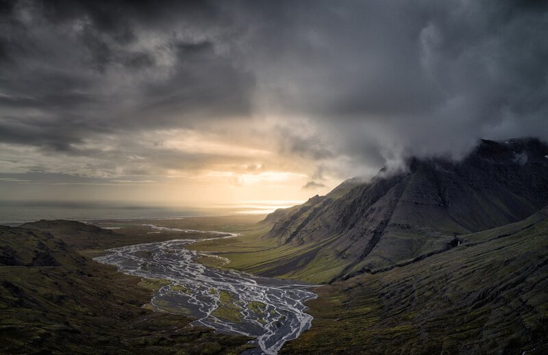 River Flowing Through Valley — Green, Dramatic, Sunset, Photograph