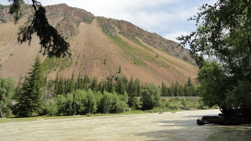 River Flowing Through Valley — Green, Serene, Afternoon, Photograph, Mountain, Trees, Road