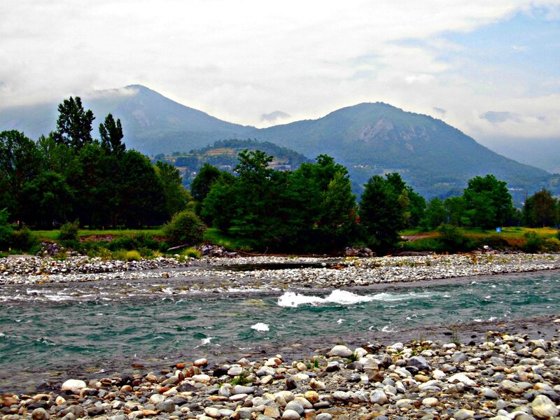 River Flowing Through Valley — Green, Serene, Afternoon, Photograph, Mountains, Trees, Rocks, Blue