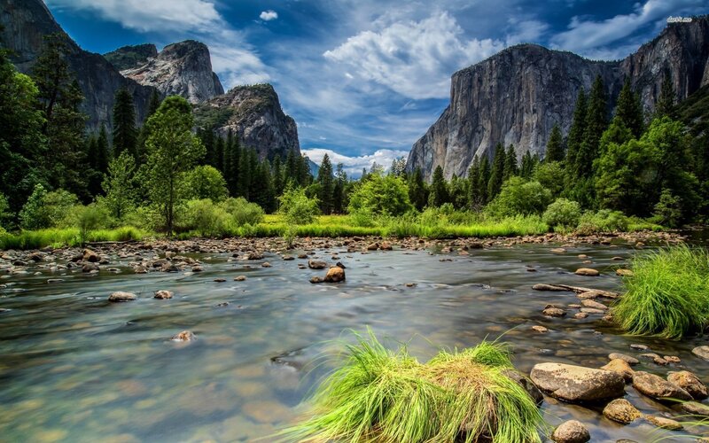 River Flowing Through Valley — Green, Serene, Afternoon, Photograph, Mountains, Trees, Rocks