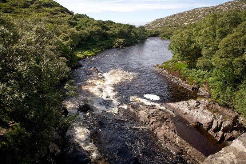 River Flowing Through Valley — Green, Serene, Afternoon, Photograph, Trees, Rocks, Rapids, Brown