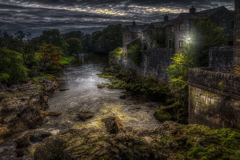River Flowing Through Village — Gray
