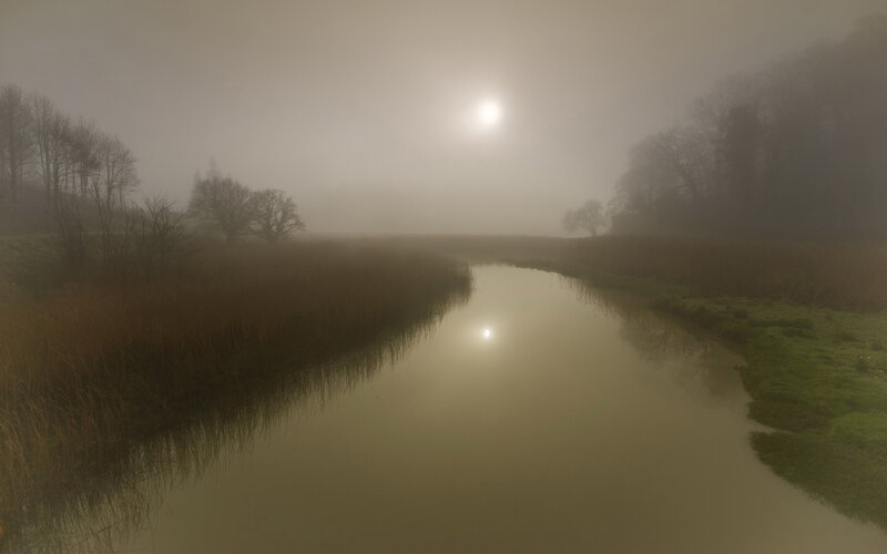 River in Foggy Landscape