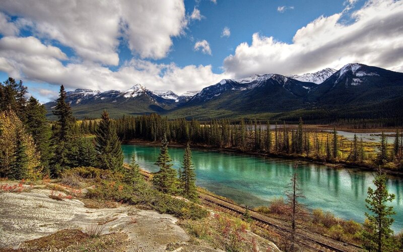 River in Mountain Valley — Blue, Serene, Afternoon, Photograph, Mountains, Forest, Train Tracks, Green, Brown