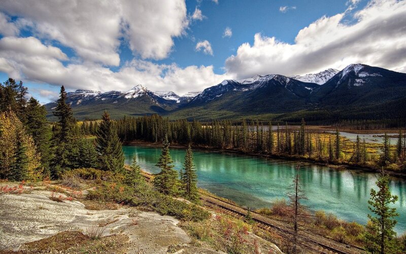 River in Mountain Valley — Blue, Serene, Afternoon, Photograph, Mountains, Forest, Train Tracks, Green