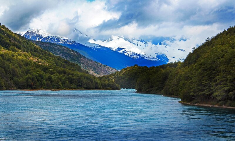 River in Mountain Valley — Blue, Serene, Afternoon, Photograph, Mountains, Trees, Clouds, Green, White