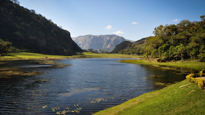 River in Mountain Valley — Blue, Serene, Afternoon, Photograph, Mountains, Trees, Grass, Green