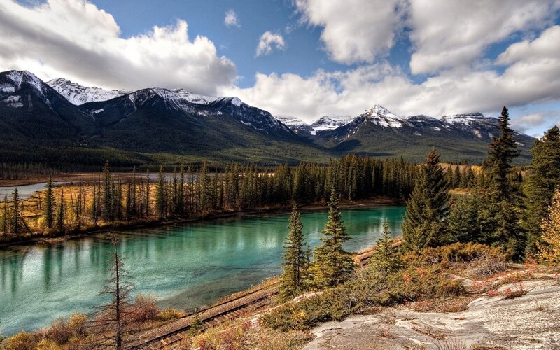 River in Mountain Valley — Blue, Serene, Autumn, Photograph, Mountains, Trees, Train Tracks