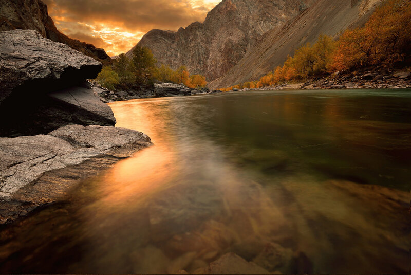 River in Mountain Valley — Orange, Dramatic, Sunset, Photograph, Mountains, Trees, Rocks