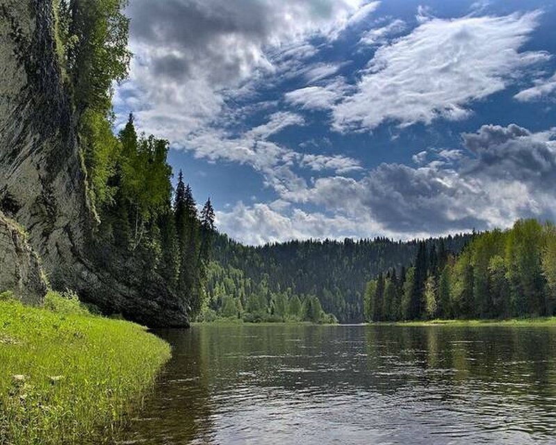 River landscape with forest and cliffs