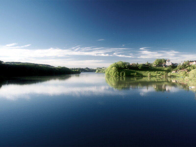 River Landscape with Village — Blue, Serene, Afternoon, Photograph, Trees
