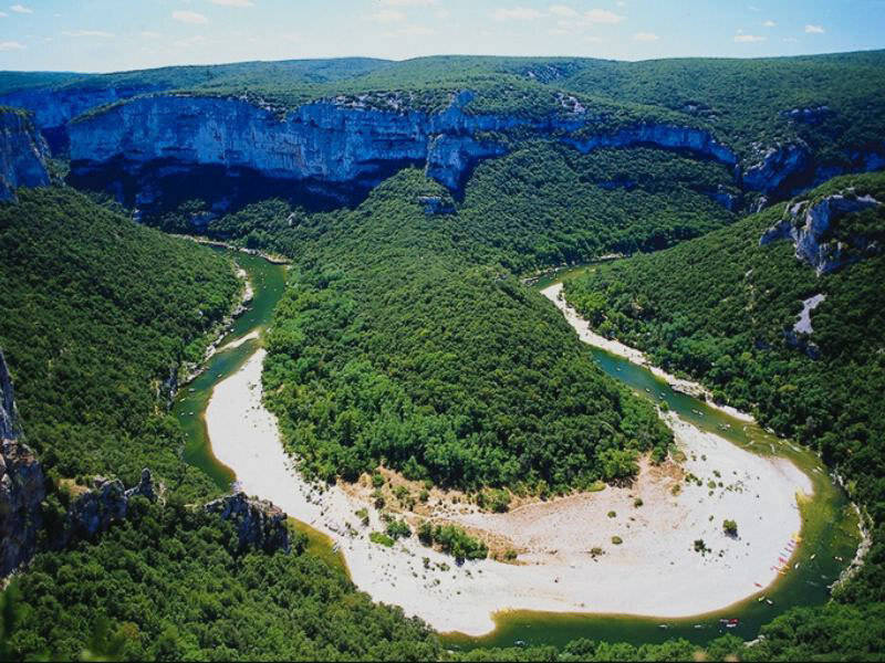 river meandering through canyon